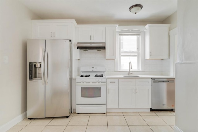 204 Maple St, Boston, MA 02132 - kitchen featuring stainless steel appliances, under cabinet range hood, tasteful backsplash, white cabinets, and light countertops