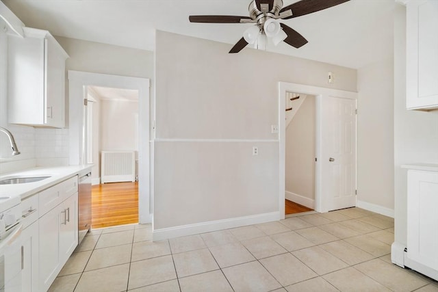 204 Maple St, Boston, MA 02132 - kitchen with light countertops, a ceiling fan, light tile patterned flooring, stainless steel dishwasher, and white cabinets