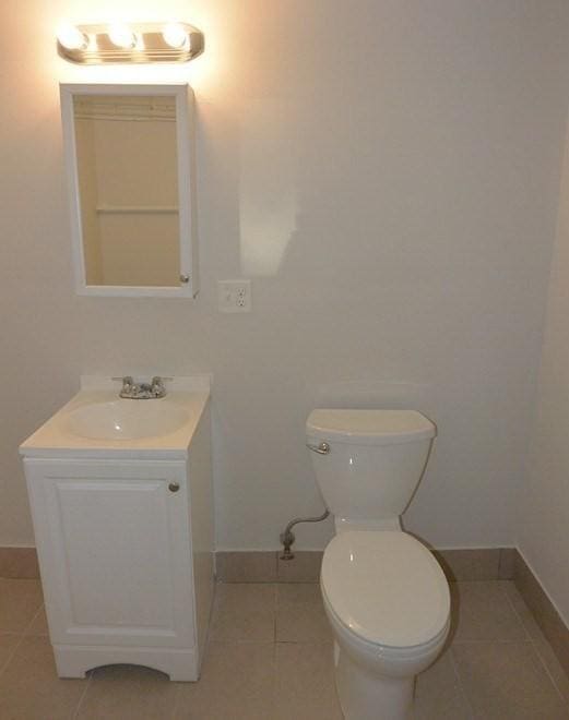 204 Maple St, Boston, MA 02132 - half bathroom featuring vanity and tile patterned flooring