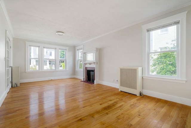 204 Maple St, Boston, MA 02132 - unfurnished living room with radiator, ornamental molding, light wood-type flooring, and a brick fireplace