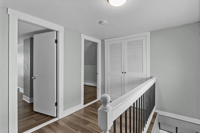 hallway with dark hardwood / wood-style floors and a baseboard radiator