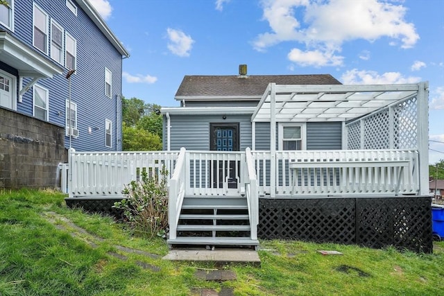 back of house with a pergola and a deck