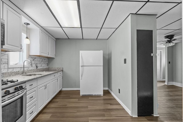 kitchen with a paneled ceiling, sink, white refrigerator, range, and white cabinetry