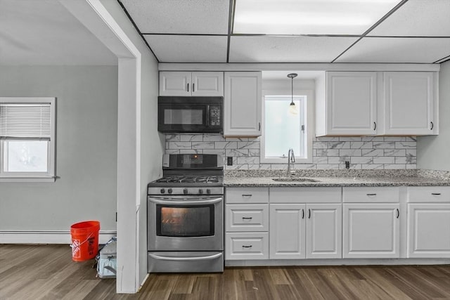 kitchen with sink, a paneled ceiling, white cabinetry, and stainless steel range with gas stovetop