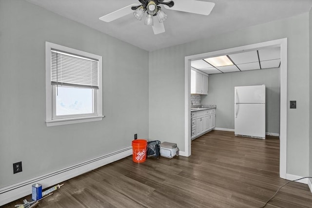 kitchen featuring white cabinetry, a baseboard radiator, dark hardwood / wood-style floors, white refrigerator, and backsplash