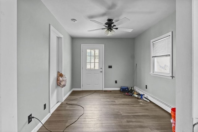 foyer with ceiling fan, hardwood / wood-style flooring, and a baseboard heating unit