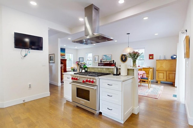 12 Lester Ter, Somerville, MA 02144 - kitchen with island exhaust hood, premium range, white cabinetry, light countertops, and light wood finished floors