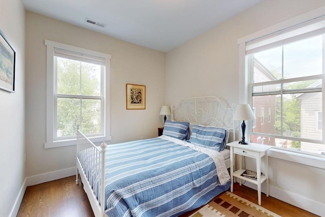 12 Lester Ter, Somerville, MA 02144 - bedroom with multiple windows, baseboards, and wood finished floors