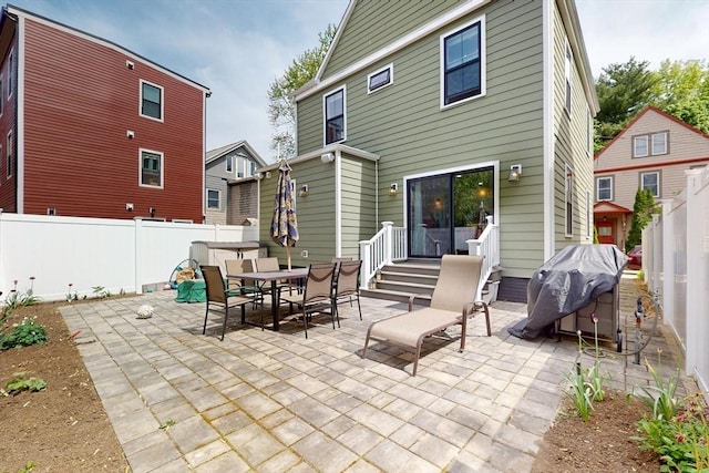 12 Lester Ter, Somerville, MA 02144 - rear view of house with a fenced backyard, a patio, and outdoor dining area