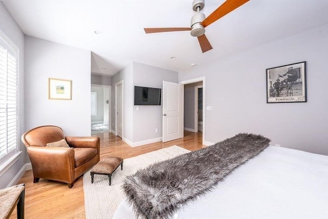 bedroom featuring baseboards, a ceiling fan, and light wood-style floors