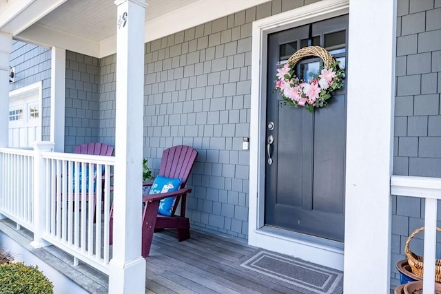 entrance to property with a porch and visible vents