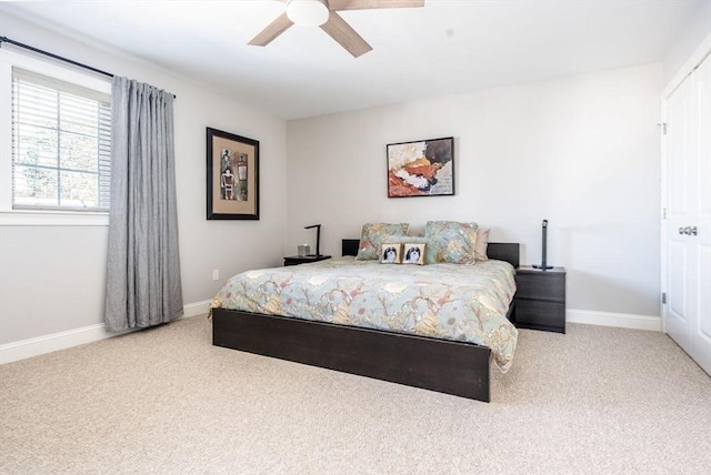 carpeted bedroom with a ceiling fan and baseboards