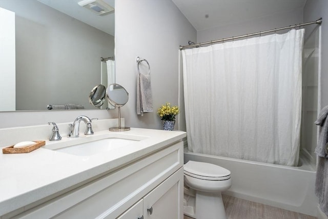 bathroom featuring visible vents, vanity, shower / bath combination with curtain, and toilet