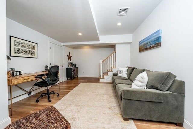 office space with recessed lighting, visible vents, baseboards, and wood finished floors