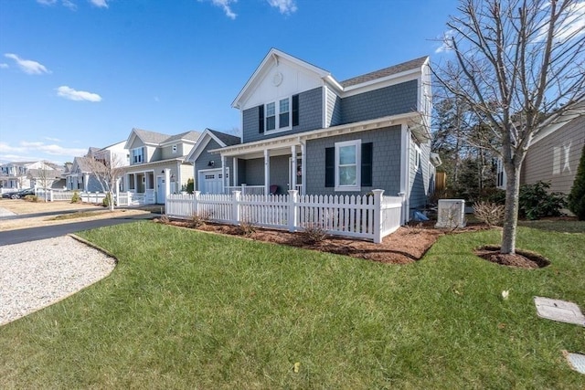 view of front of house featuring a fenced front yard, a garage, driveway, a residential view, and a front yard