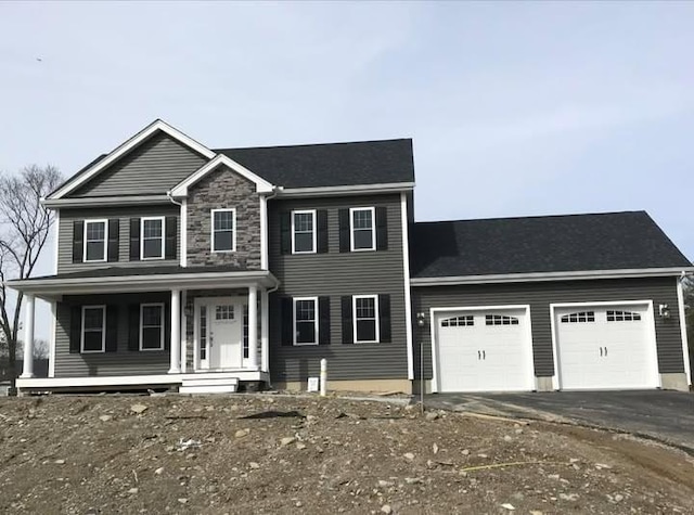 view of front of property featuring covered porch and a garage