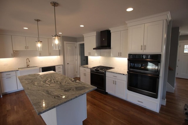 kitchen with black appliances, white cabinetry, and wall chimney range hood