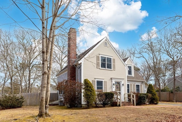 view of front of home with fence and a chimney