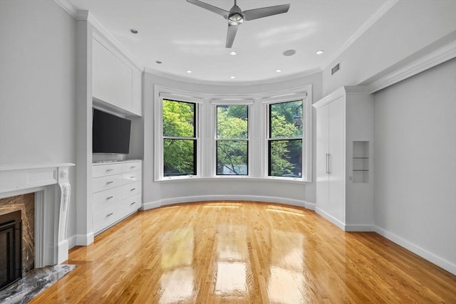 316 Beacon St Unit 1, Boston, MA 02116 - unfurnished living room with a high end fireplace, ceiling fan, light wood-style floors, and crown molding