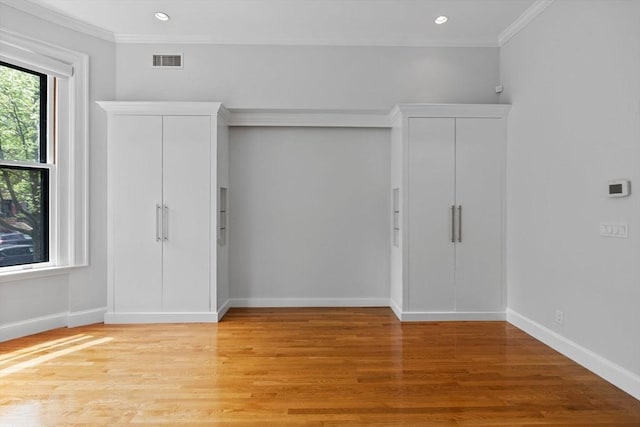 316 Beacon St Unit 1, Boston, MA 02116 - unfurnished bedroom featuring crown molding, light wood-type flooring, recessed lighting, and two closets