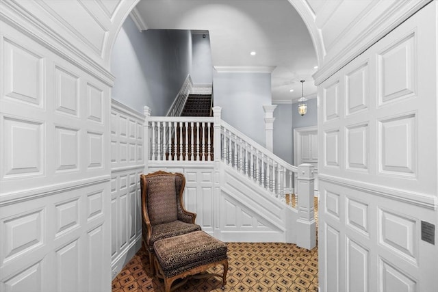 316 Beacon St Unit 1, Boston, MA 02116 - staircase with ornamental molding, arched walkways, a decorative wall, and recessed lighting