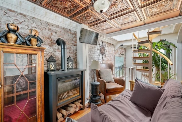 sitting room with hardwood / wood-style flooring and a wood stove