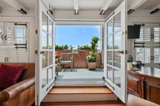 doorway to outside featuring french doors and beamed ceiling