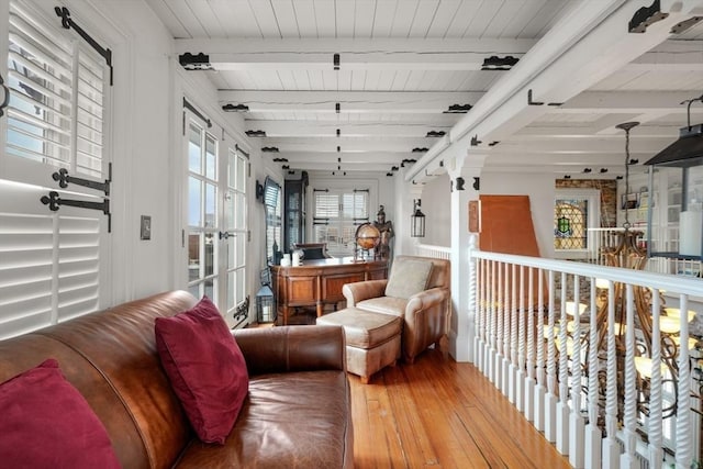 living room with beam ceiling and hardwood / wood-style flooring