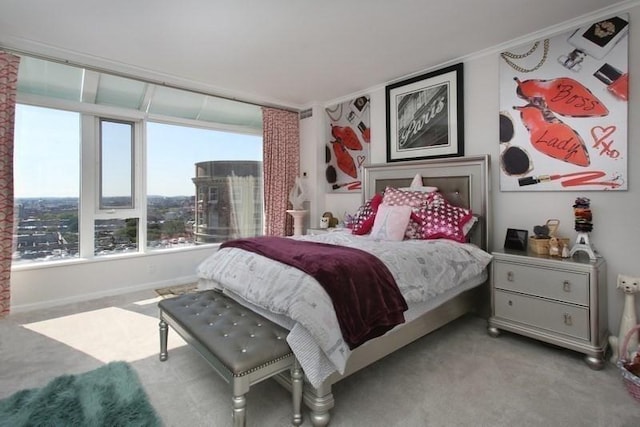 bedroom with ornamental molding and light carpet