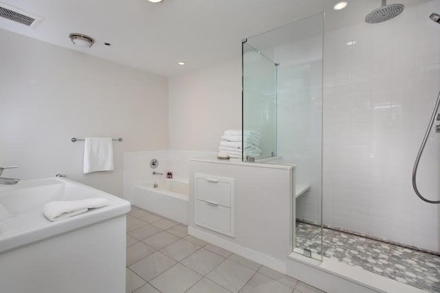 bathroom with separate shower and tub and tile patterned floors