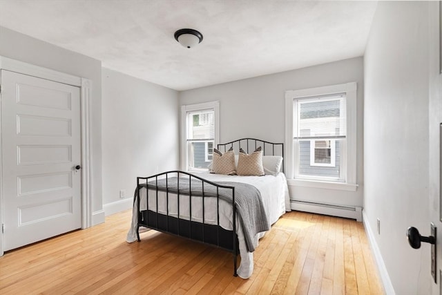 59-61 Elm St, Andover, MA 01810 - bedroom featuring baseboard heating and light wood-type flooring