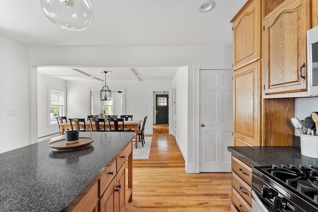 59-61 Elm St, Andover, MA 01810 - kitchen with light wood-style flooring, stainless steel range with gas cooktop, beamed ceiling, hanging light fixtures, and recessed lighting