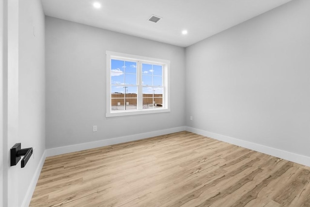 spare room with light hardwood / wood-style flooring