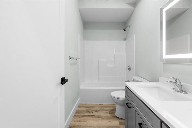 full bathroom featuring hardwood / wood-style floors, vanity, bathing tub / shower combination, and toilet