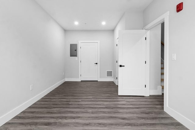 interior space with dark hardwood / wood-style floors and electric panel