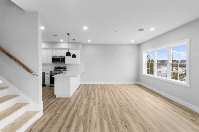 unfurnished living room featuring light wood-type flooring