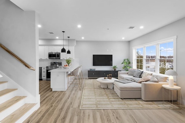 living room with light hardwood / wood-style flooring