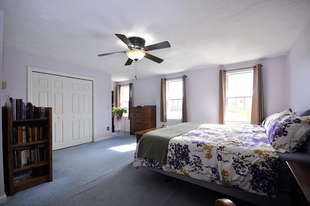 carpeted bedroom with baseboards, a ceiling fan, and a closet