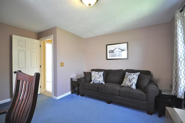 carpeted living area with baseboards