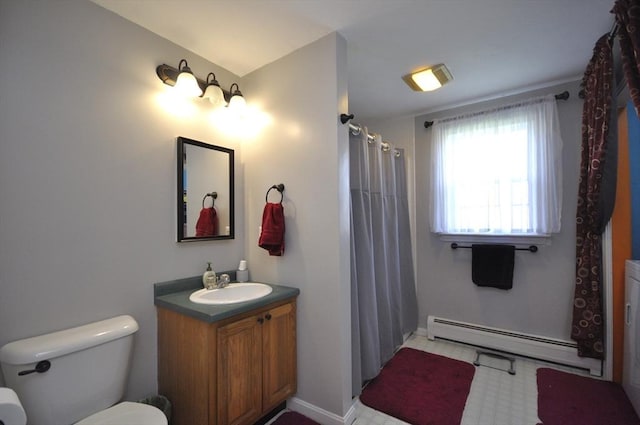 bathroom featuring baseboard heating, vanity, toilet, tile patterned floors, and baseboards