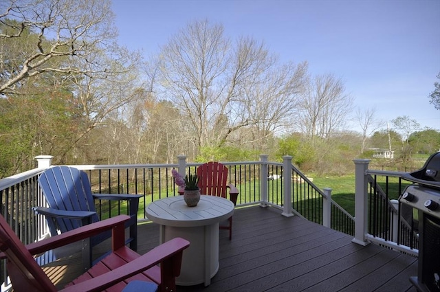 wooden terrace with a yard and grilling area