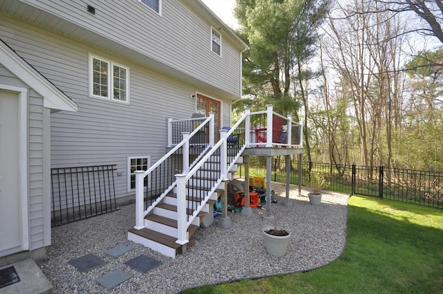exterior space featuring fence, a yard, stairway, and a deck
