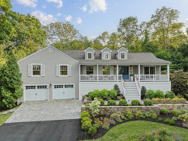 18 Windy Hill Rd, Cohasset, MA 02025 - view of front of property with a porch, a garage, asphalt driveway, stairs, and roof with shingles