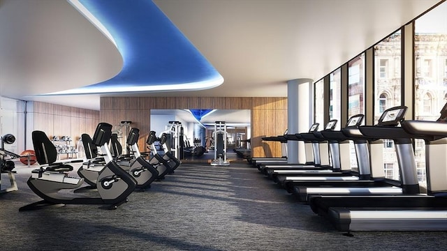 gym with carpet floors and wood walls