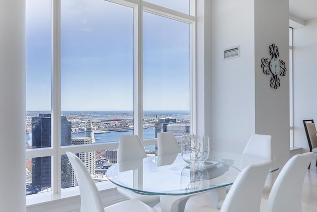 dining room featuring a view of city and a water view