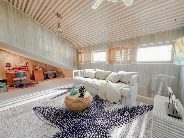 living area featuring wooden walls and a ceiling fan
