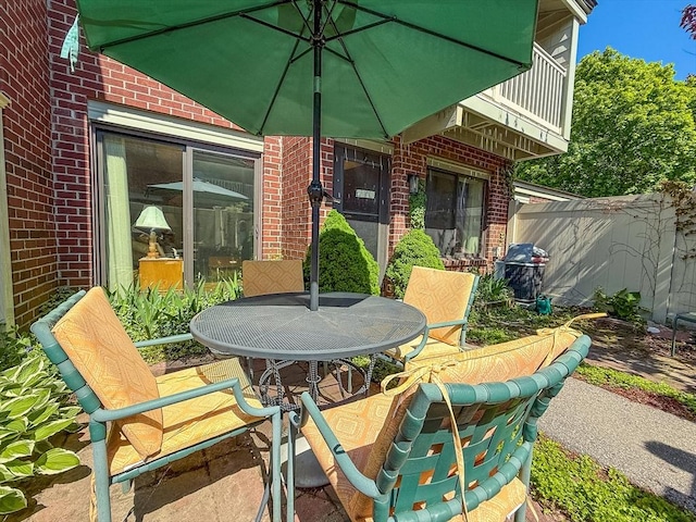 view of patio / terrace featuring fence and outdoor dining area