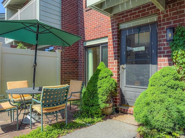 view of patio featuring fence and outdoor dining area