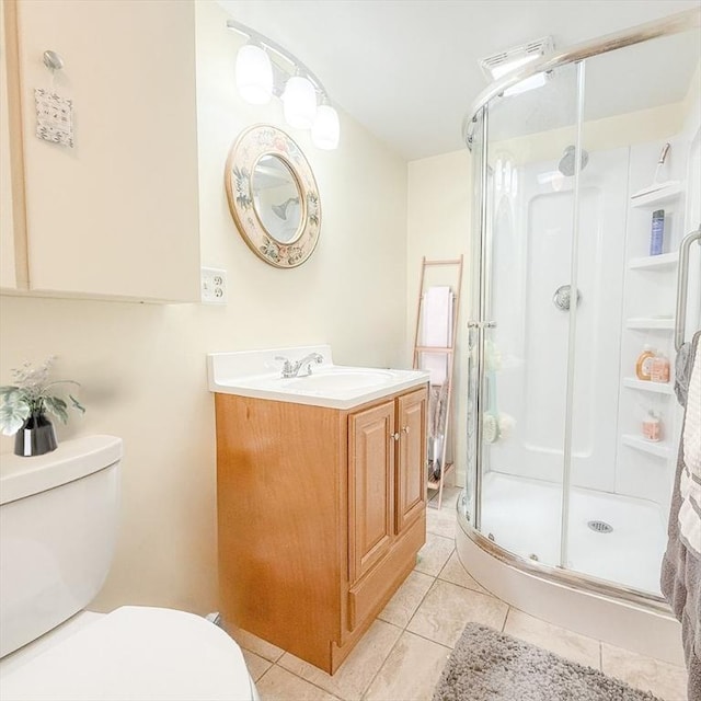 full bath featuring tile patterned flooring, toilet, a stall shower, and vanity
