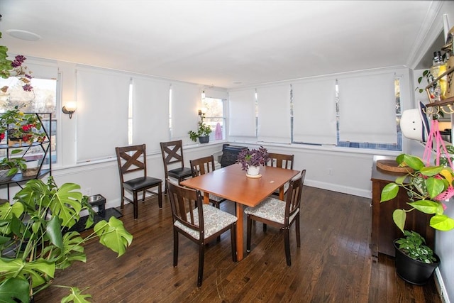 dining space with dark hardwood / wood-style flooring